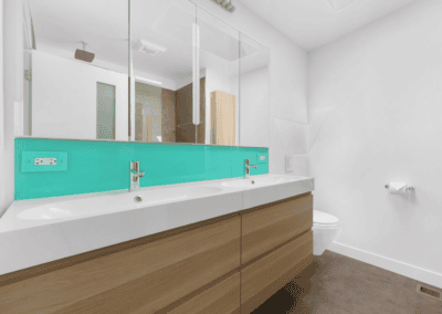 Modern bathroom with freshly painted white walls and a wood floating vanity