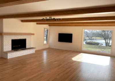 Family room painting with light beige walls and a white brick fireplace in Northbrook