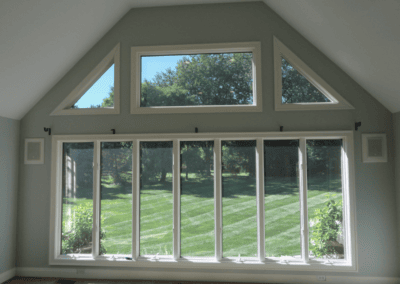 Vaulted room with fresh sage gray walls and white window trim in Highland Park
