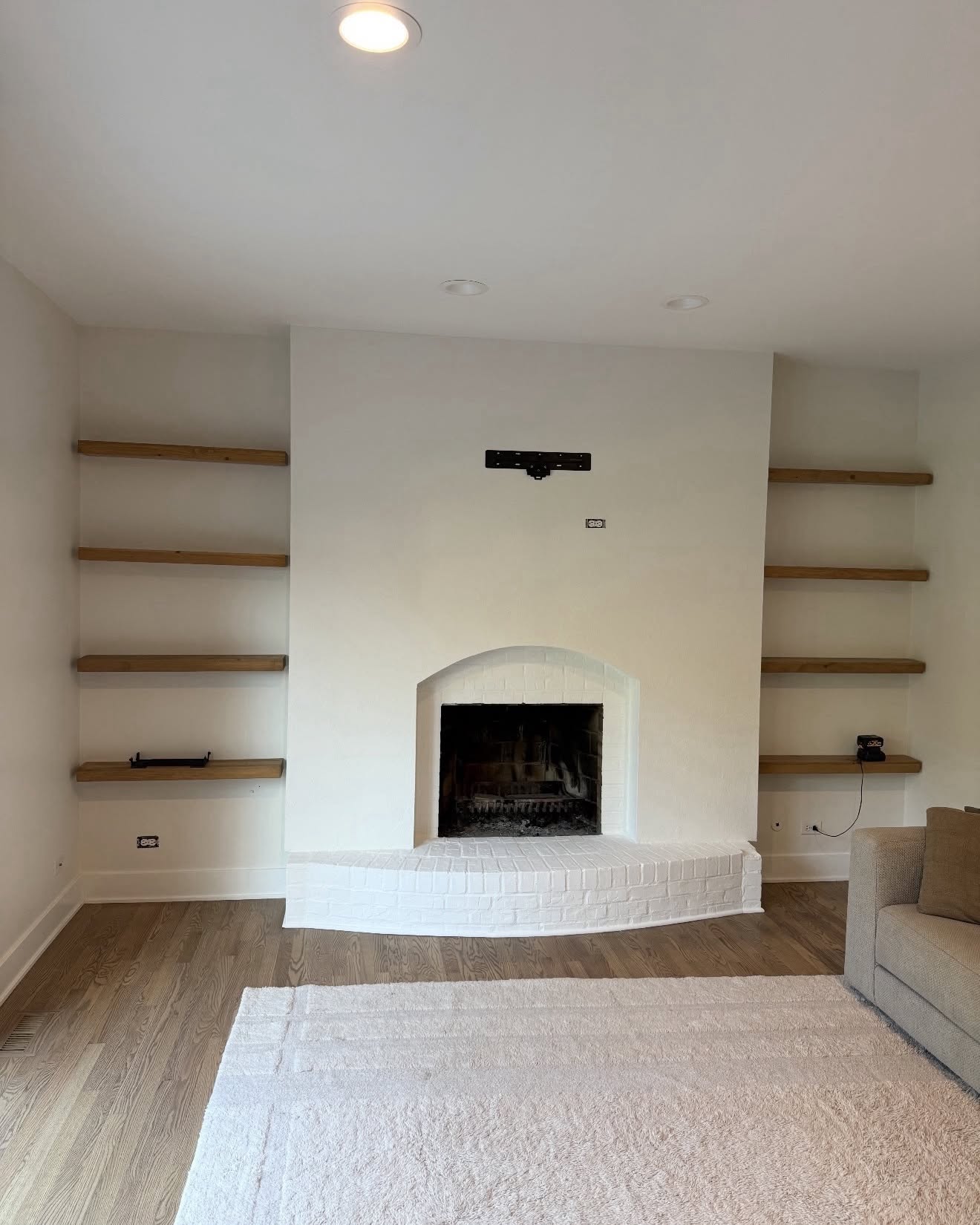 Completed fireplace feature wall painting in Park Ridge IL by Sunpainting, smooth warm white walls with painted brick surround and hearth