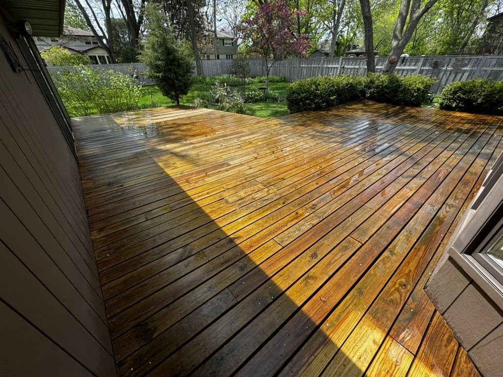 Clean wet wood deck after power washing by Sunpainting