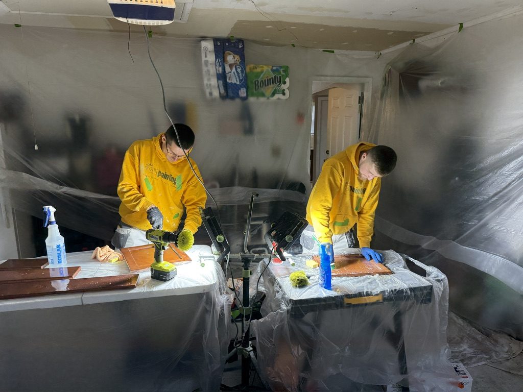 Sunpainting painters degreasing cabinet doors before painting