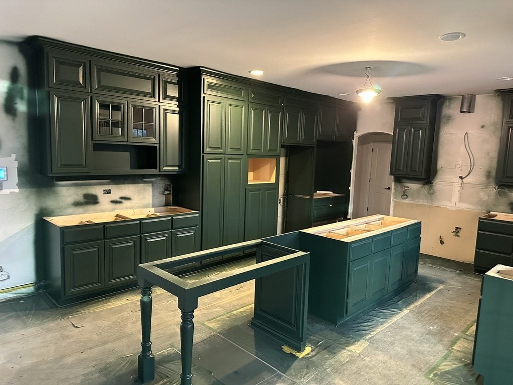Deep green kitchen cabinets being spray painted by Sunpainting