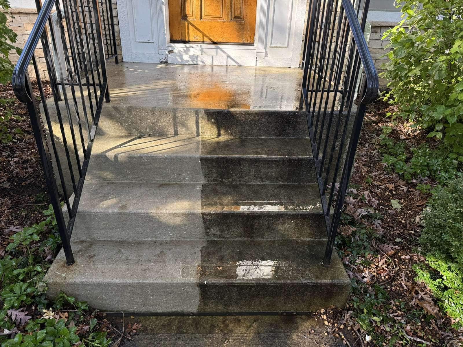Sunpainting power washing concrete front steps, cleaned half next to uncleaned half