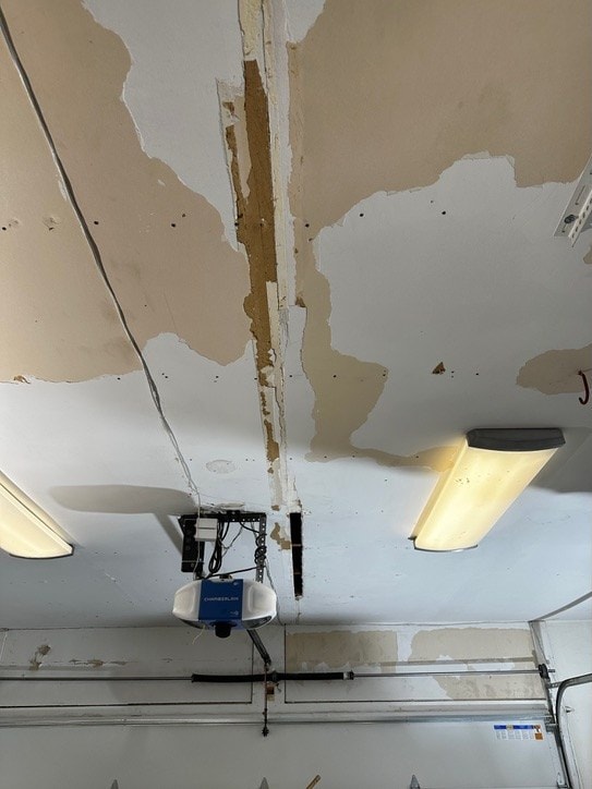 Garage ceiling with peeling paper and paint before repair