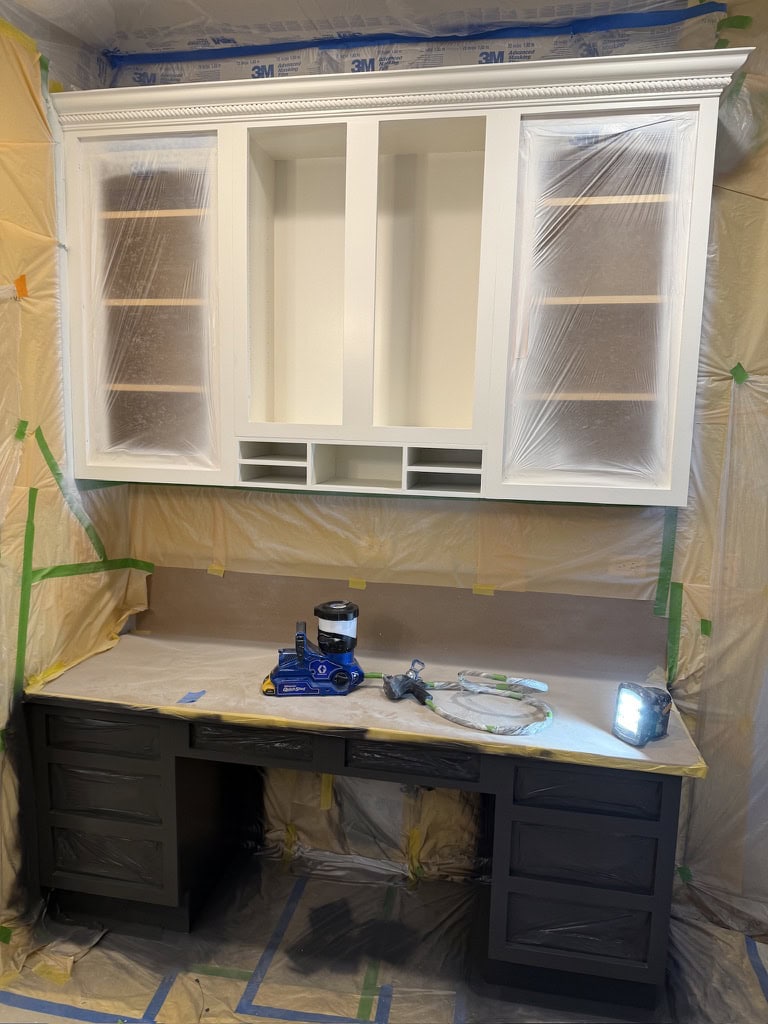 White built-in hutch cabinet being spray painted by Sunpainting